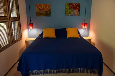 Uma cama ou camas num quarto em Chalé Aroeira Taiba