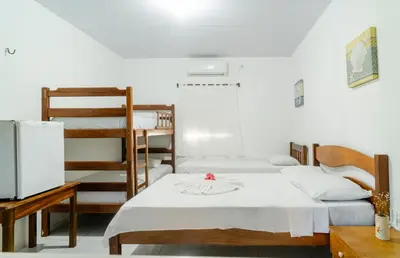 Uma cama ou camas num quarto em Pousada Zé Patinha