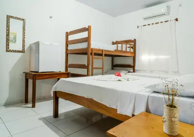Uma cama ou camas num quarto em Pousada Zé Patinha