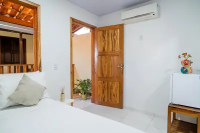 Uma cama ou camas num quarto em Pousada Zé Patinha