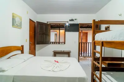 Uma cama ou camas num quarto em Pousada Zé Patinha