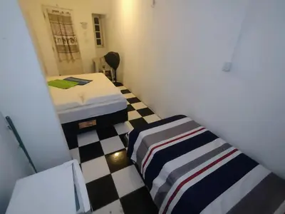 Uma cama ou camas num quarto em Pousada Casa da Perla