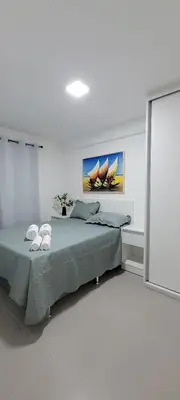 Uma cama ou camas num quarto em Flat Beira-mar Fortaleza