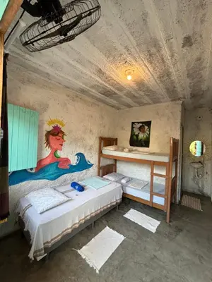 Uma cama ou camas num quarto em Hostel Flor da Vida