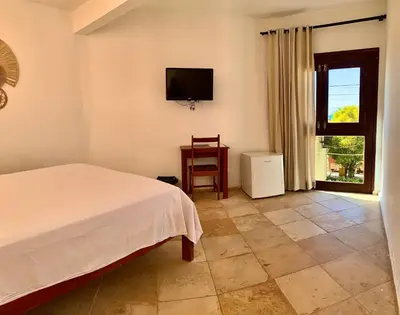 Uma cama ou camas num quarto em Pousada Borboleta