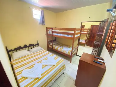 Uma cama ou camas num quarto em Pousada do Ary