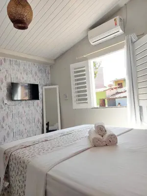 Uma cama ou camas num quarto em Na Casa Delas Jericoacoara