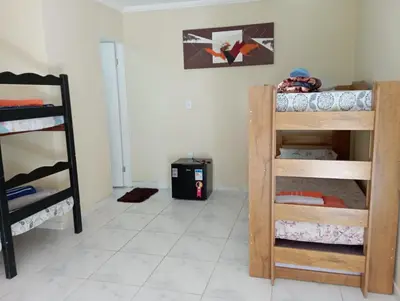 Uma cama ou camas num quarto em Aconchego da Nina