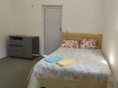 Uma cama ou camas num quarto em Aconchego da Nina