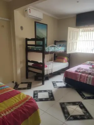Uma cama ou camas num quarto em Aconchego da Nina