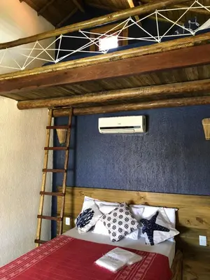 Uma cama ou camas num quarto em Pousada Rosa dos Ventos Lagoinha