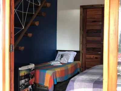 Uma cama ou camas num quarto em Pousada Rosa dos Ventos Lagoinha