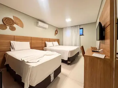 Uma cama ou camas num quarto em Paraiso Beach Hotel