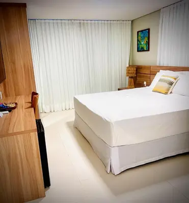 Uma cama ou camas num quarto em Paraiso Beach Hotel