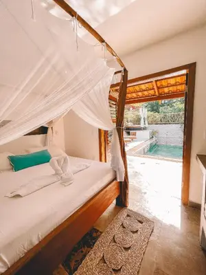 Uma cama ou camas num quarto em Pousada Fortal Preá