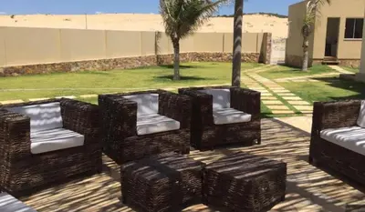 Uma área de estar em Vilas na Praia Residence Canoa Quebrada CE Apartamento PÉ NA AREIA superior com 2 suítes, vista para a Praia e Dunas e com privacidade total