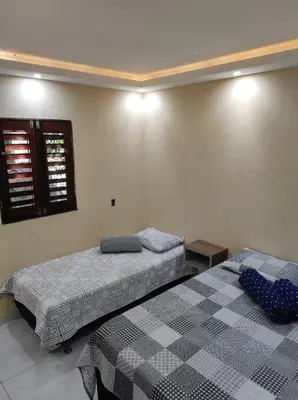 Uma cama ou camas num quarto em Aconchego do Áureo