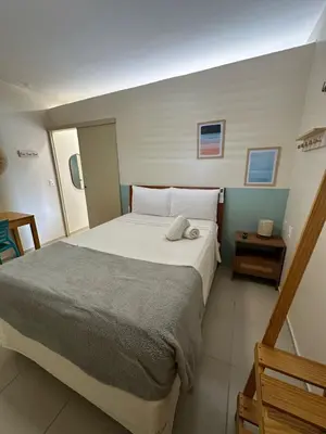 Uma cama ou camas num quarto em Viva Praia Flats, maravilhosa hospedagem na praia!