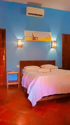 Uma cama ou camas num quarto em Pousada Villa Mariposa