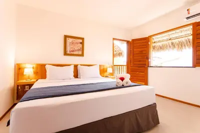 Uma cama ou camas num quarto em UNKUÉ POUSADA FLATS