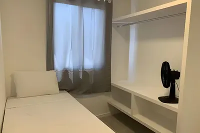 Uma cama ou camas num quarto em Hosts BR - Apartamentos funcionais