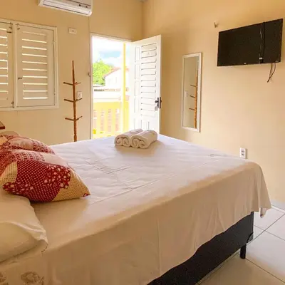 Uma cama ou camas num quarto em Encanto do Sol Hospedagem