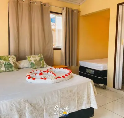 Uma cama ou camas num quarto em Encanto do Sol Hospedagem