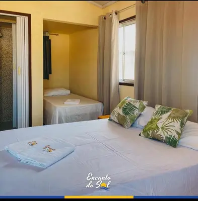 Uma cama ou camas num quarto em Encanto do Sol Hospedagem
