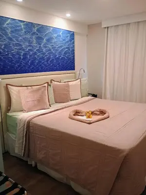 Uma cama ou camas num quarto em Top Flat Fortaleza