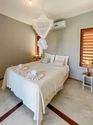 Uma cama ou camas num quarto em Casa super charmosa com piscina em Icaraizinho!