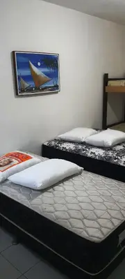 Uma cama ou camas num quarto em Pousada Savoy