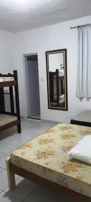 Uma cama ou camas num quarto em Pousada Savoy