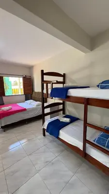Uma cama ou camas num quarto em Pousada Linhares