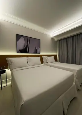 Uma cama ou camas num quarto em Tintto Hotel