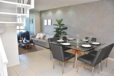 Uma área de estar em TERRAMARIS DUPLEX LUXO - FRENTE MAR
