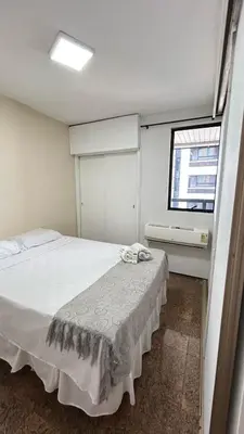 Uma cama ou camas num quarto em Flat Atlântico Neto