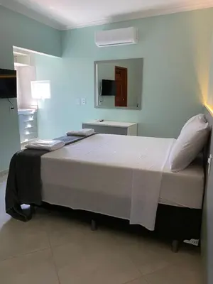 Uma cama ou camas num quarto em Pousada Maanain