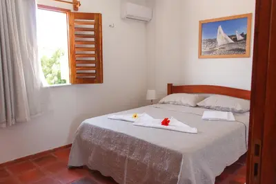 Uma cama ou camas num quarto em Apartamentos da Jangada