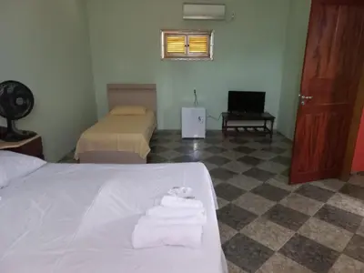 Uma cama ou camas num quarto em Pousada Rio e Mar