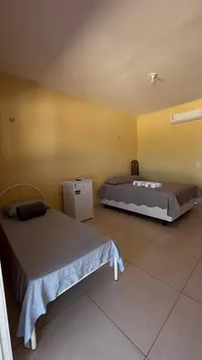 Uma cama ou camas num quarto em Pousada Rio e Mar