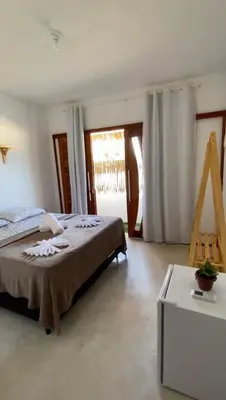 Uma cama ou camas num quarto em Suíte Paradise