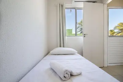 Uma cama ou camas num quarto em Beach Townhouses #C5 - Aconchego por Carpediem