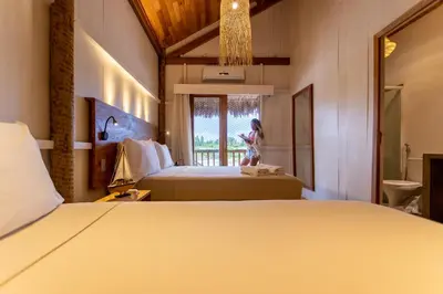 Uma cama ou camas num quarto em CASA na PRAIA DA BARRINHA Frente Mar
