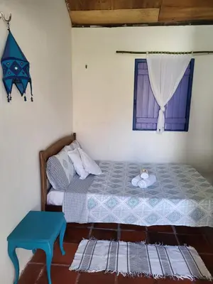 Uma cama ou camas num quarto em Chalé Flor do Ser