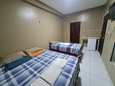 Uma cama ou camas num quarto em Pousada Meireles Praia