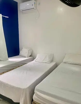 Uma cama ou camas num quarto em Happy Hostel e Pousada Paracuru