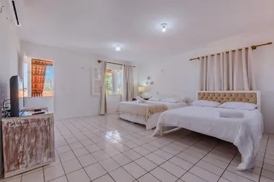 Uma cama ou camas num quarto em Casa em Porto das Dunas por Carpediem