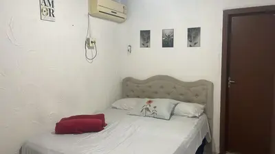 Uma cama ou camas num quarto em Pousada Carimbó