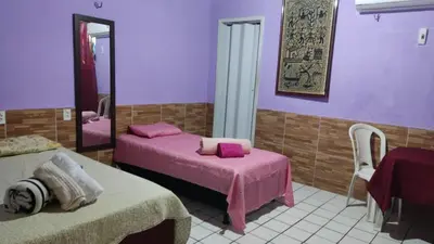 Uma cama ou camas num quarto em Pousada Carimbó