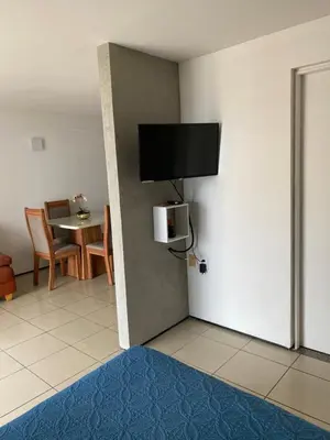 Uma televisão e/ou sistema de entretenimento em Flat com vista para o Mar